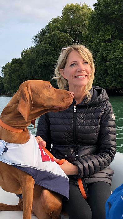 Cindy with her dog on a boat